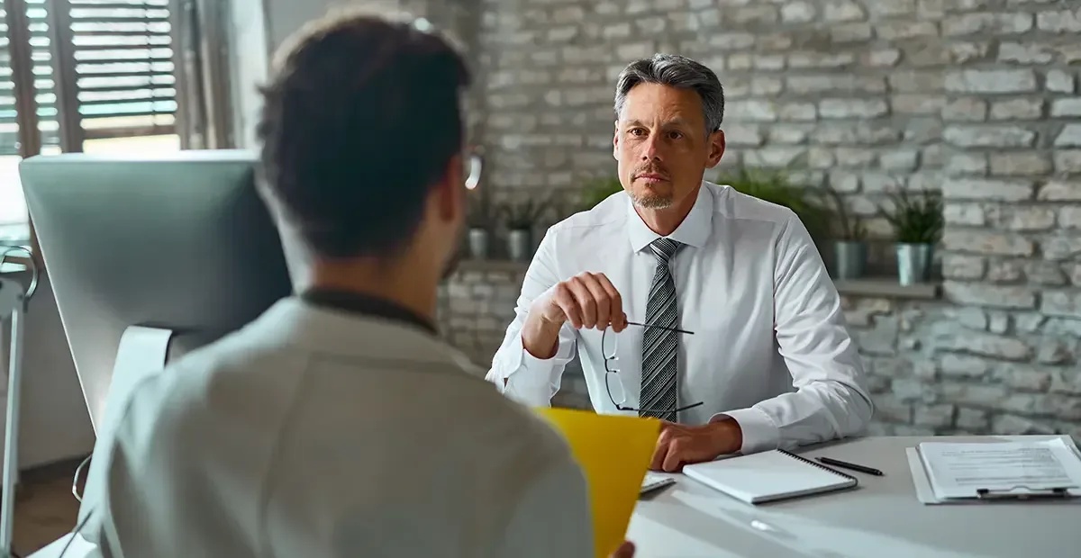A manager listening carefully to an employee in a one-on-one meeting