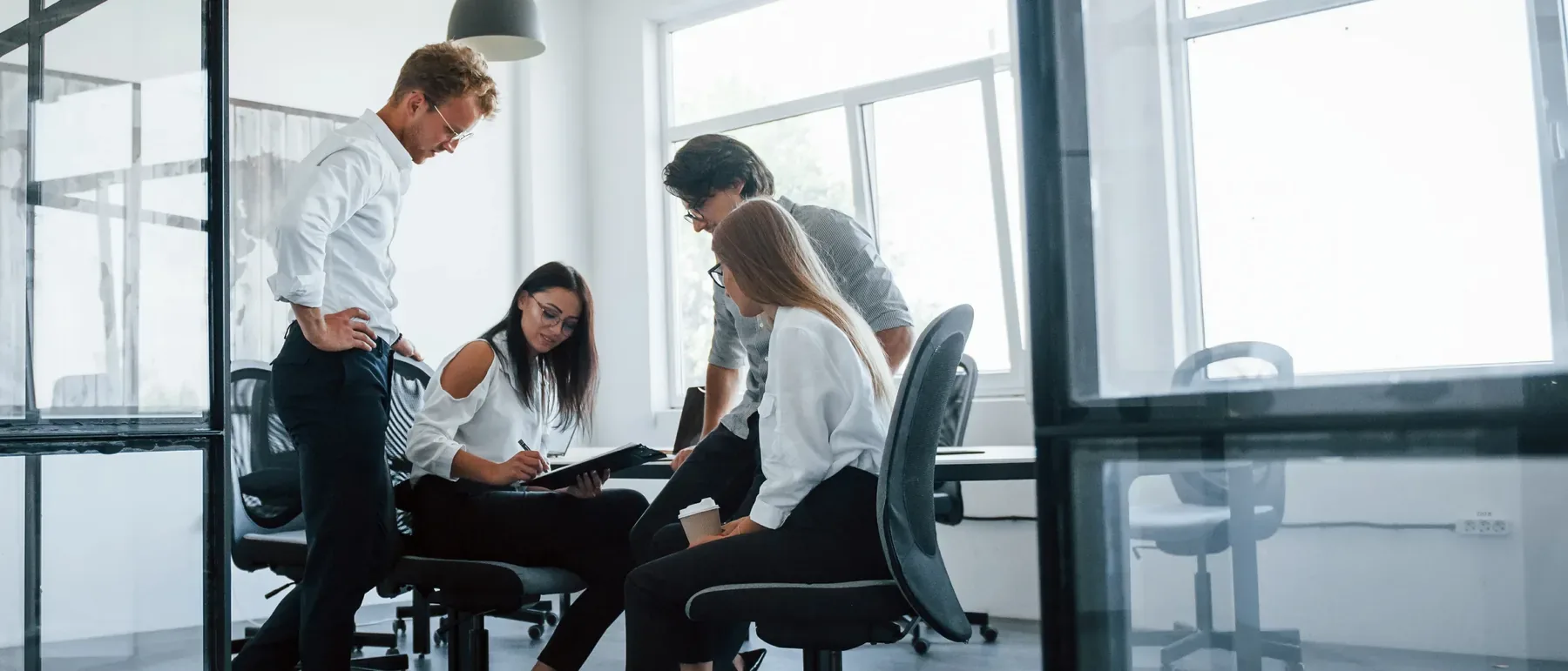 Team working through a compliance workshop in a meeting room